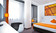 Standard double room with orange interior in Wyndham Garden Düsseldorf City Centre