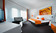 Satndard double room with orange interior in Düsseldorf City Centre hotel